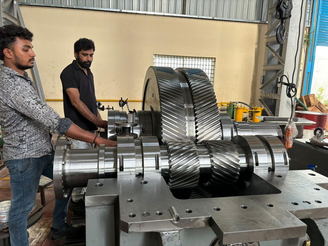 SGE technicians working on a large precision gear assembly